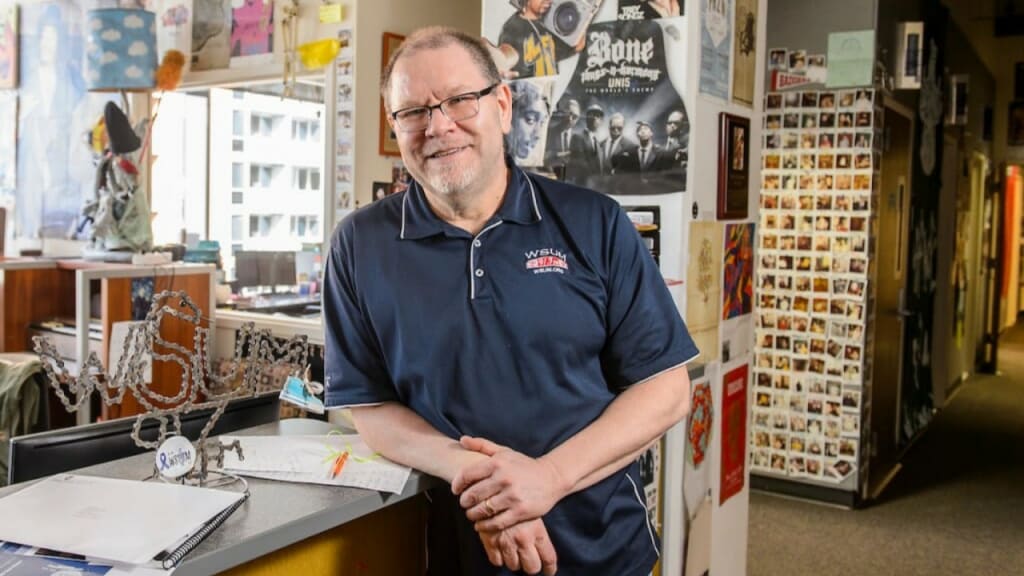 In a photo by Bryce Richter, Dave Black, co-founder of WSUM 91.7 FM, leans against a desk.