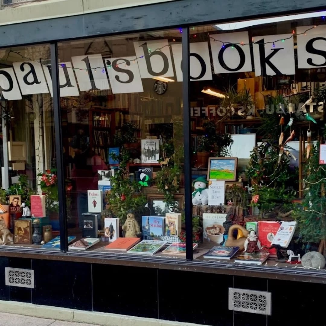 Image of Paul's Book, with painted letter signs and books displayed in the front window. 