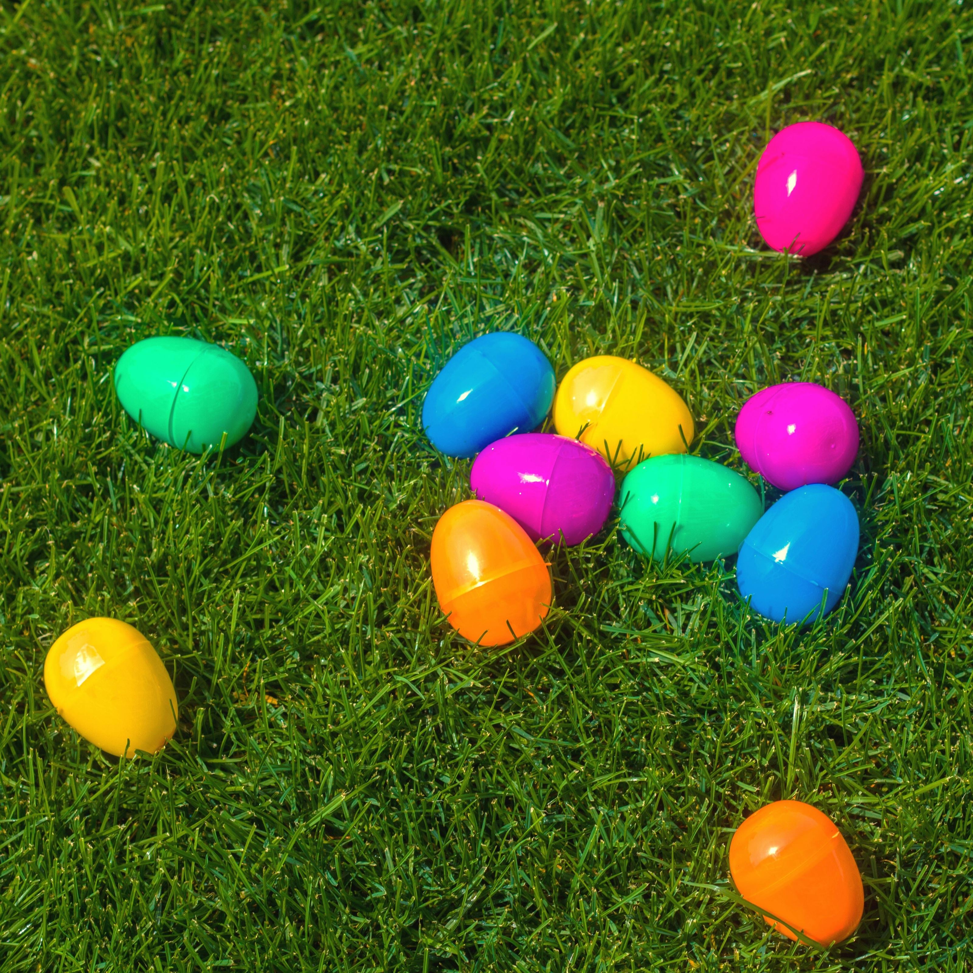 Brightly-colored plastic Easter eggs in the grass.