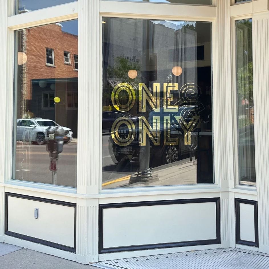 A picture of the front window of One & Only.