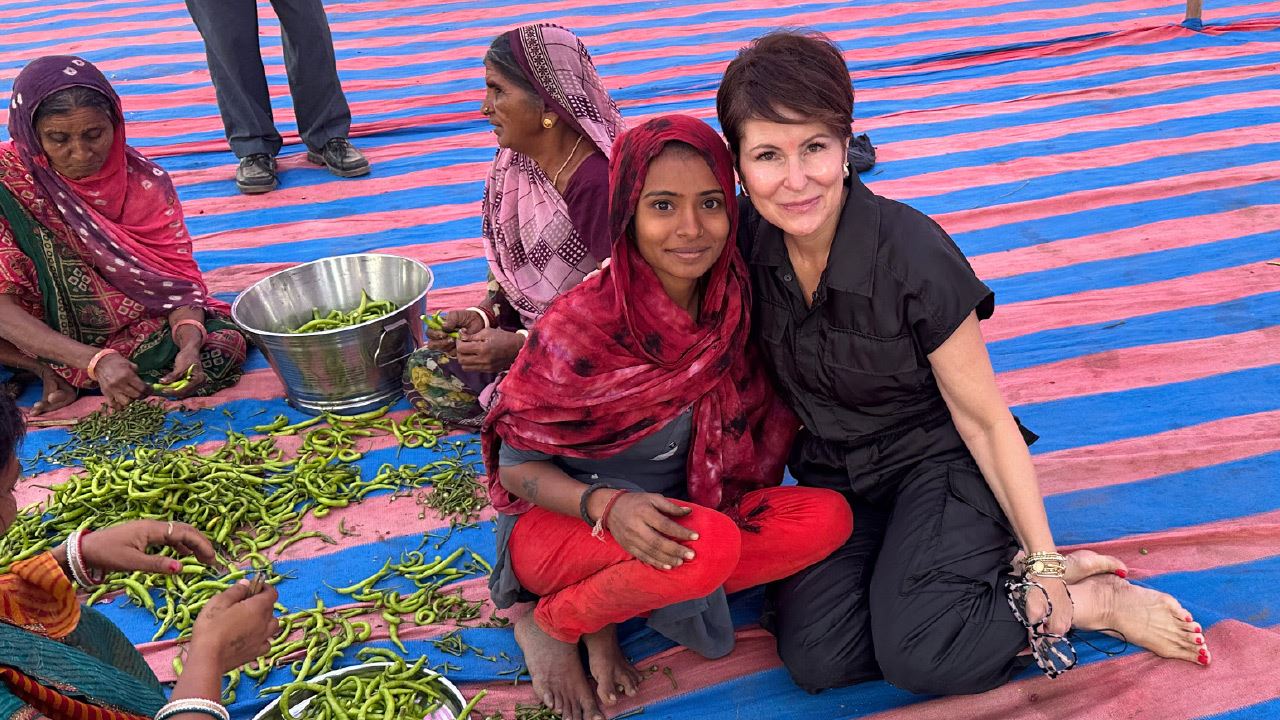 Lora Klenke (right) poses with women in India.